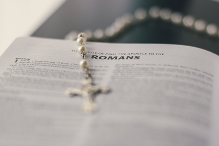 An open bible is placed on a black desktop.の写真素材