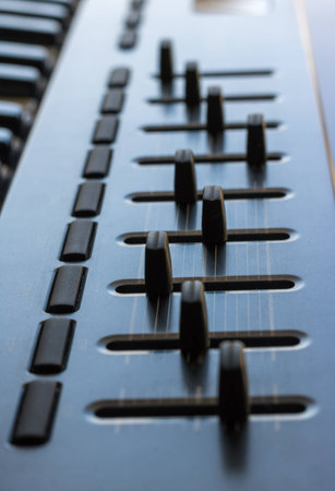 An electronic keyboard is set in a bright room. It has an 8 channel control board built in with...