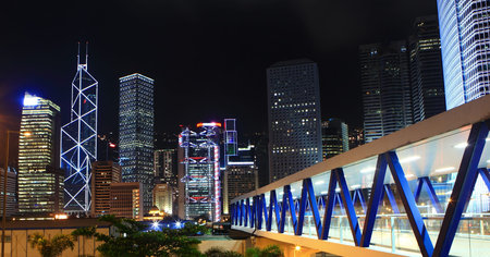 City night scene with modern skyscraper and buildings in Hong Kong, Asia. 