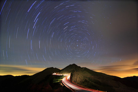 Night sky with star tracks in the mountains 