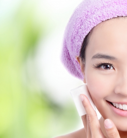 Close up of Young Girl remove makeup by Cleansing Cotton with green background, Model is a asian Beauty