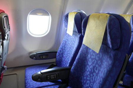 Airplane blue seat and window inside an aircraftのeditorial素材