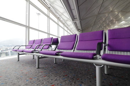 row of purple chair at airport in Hongkongのeditorial素材