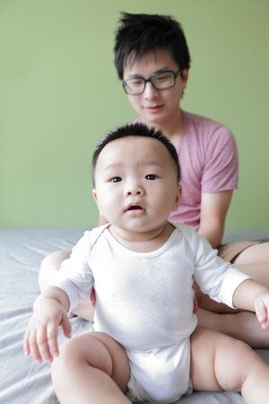 Baby and Father Happy Smile Face with green home background, Model are asian family
