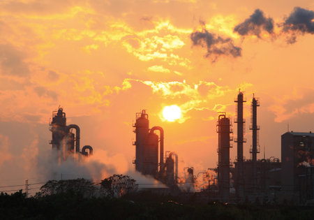 Air pollution smoke from pipes and factory with sunset backgroundのeditorial素材