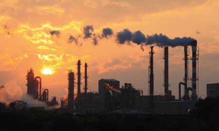 Air pollution smoke from pipes and factory with sunset backgroundのeditorial素材