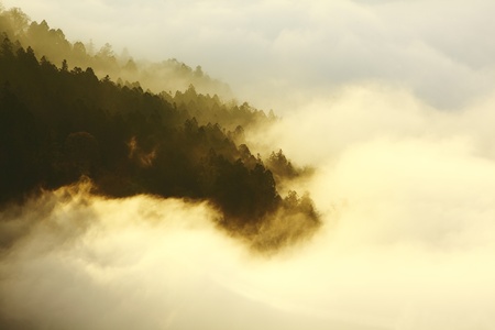dramatic Clouds rolling over mountains at sunset shot in taiwan formosa asiaの写真素材