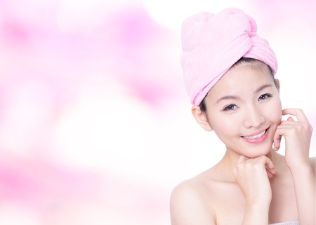 Young Woman Closeup portrait with Smile Face after bath - spa on pink background, model is a asian beautyの写真素材