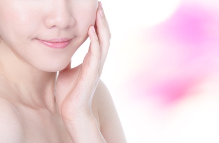 Young charming woman mouth lips close up and hand touch face with pink background, model is a asian beautyの写真素材