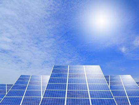 Solar panel system ,blue sky and sunshine with green grassの写真素材