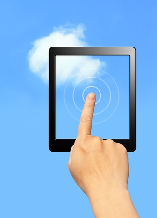 cloud computing concept. hands touch computer screen with tablet and touch pad in sky backgroundの写真素材