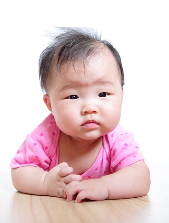 cute girl baby confuse face close up with pink cloth on white backgroundの写真素材