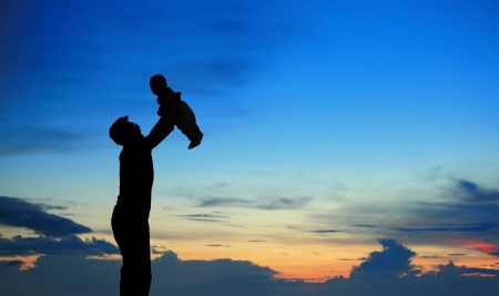 Silhouette of father and child on beautiful summer sunset - familyの写真素材