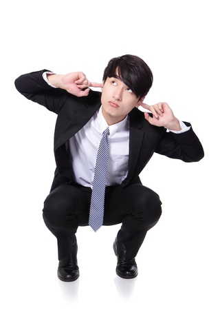 businessman hold hands to cover ears and crouch on the floor isolated on white background, asian model, concept of business man stressed, depressed, painの写真素材