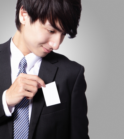 business card in business man suit pocket (great for copy space) with gray background, asian male modelの写真素材
