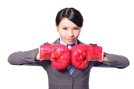 Confident modern business woman with boxing gloves isolated on whiteの写真素材