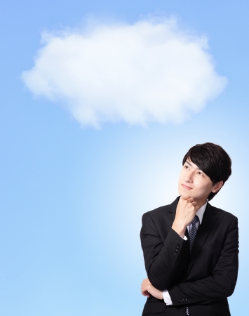 portrait of a business man thinking against a cloudy sky background, asian modelの写真素材