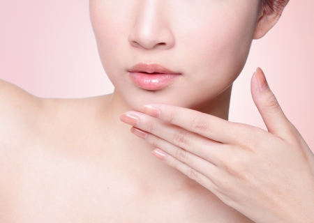 Female lips closeup. Beautiful smile of young fresh woman.  Isolated over pink background. easy for you change color of lipstick for your product, asian modelの写真素材