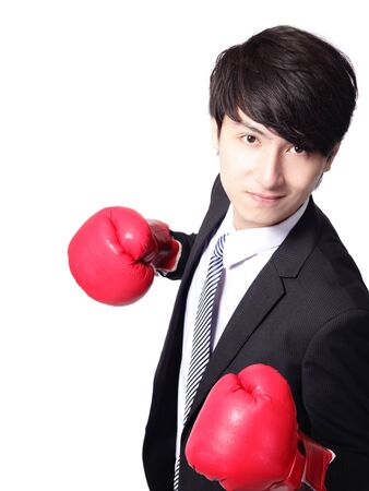 Asian businessman battle with boxing glove, isolated on white backgroundの写真素材