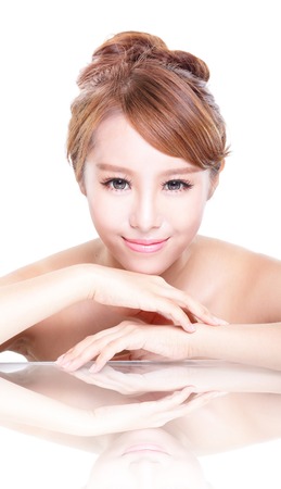 Beautiful face skincare beauty woman lying down with mirror reflection isolated on white background. asian beauty modelの写真素材