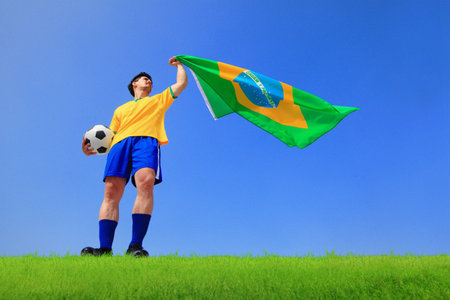Excited man holding a brazil flag with blue sky