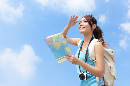 Happy travel woman look map and look copy space with sky background, asian Happy travel woman look map and look copy space with sky background, asian
