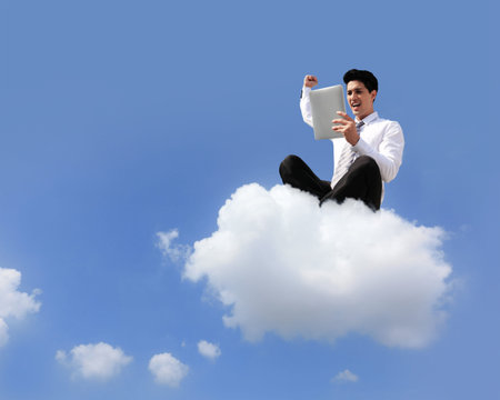 business man sitting on a cloud working with tablet pc computer , cloud computing concept
