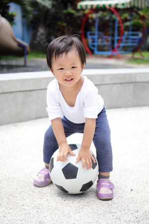 Happy child with soccer, asianの写真素材