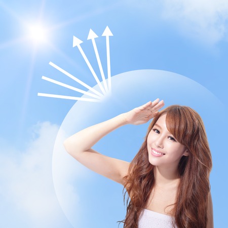 Beautiful woman face with sunshine and blue sky, concept for skin care and sun block, asian beauty