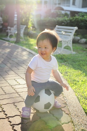 Happy child with soccer, asianの写真素材