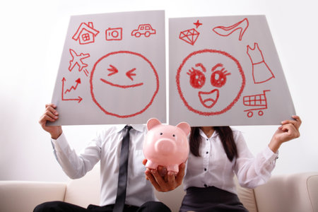 Happy couple with pink piggy bank at home, and holding billboard dream future, focus on piggy bankの写真素材