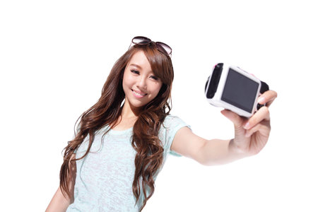 Happy travel young woman selfie taking pictures of herself isolated over white background, asian