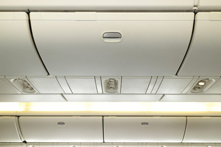 Commercial aircraft interior in airplane cabin, Overhead compartmentの写真素材