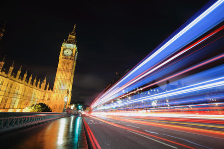 Big Ben and London at night with the lights of the cars passing by after rain, the most prominent...