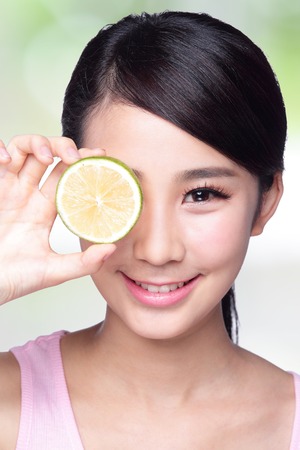 Healthy girl show lemon with smile faceの写真素材
