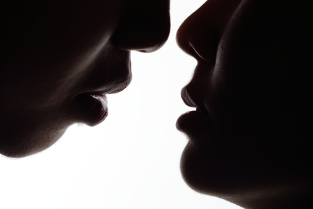 close up of silhouette lovers kiss. Isolated on white backgroundの写真素材