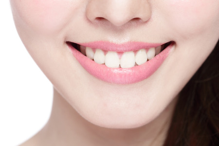 Beautiful young woman health teeth close up and charming smile. Isolated over white background, asian beautyの写真素材