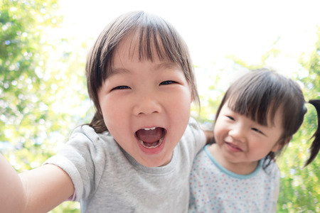 Happy child take a selfie in the park, asianの写真素材