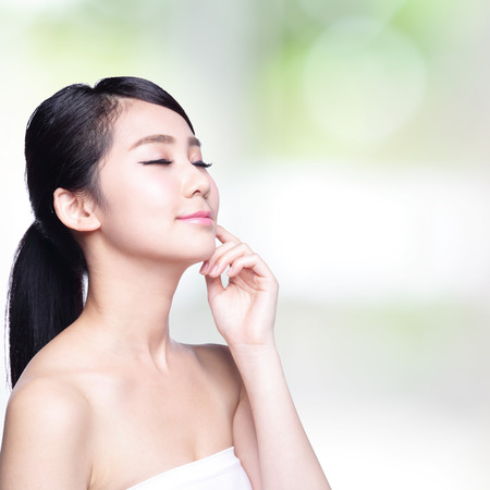 Beautiful Skin care woman Face smile and enjoy carefree isolated on nature green background. asian Beautyの写真素材