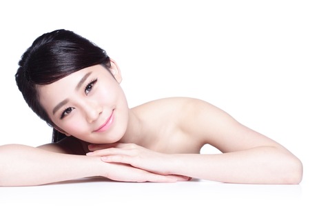 Charming woman face Smile to you close up while lying isolated on white background, asian girlの写真素材