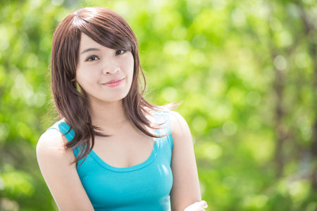 young health woman smile to you. nature green background, asian beautyの写真素材