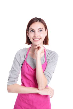 Happy young woman housewife think and look something and she is wearing Kitchen Apron isolated Over White Backgroundの写真素材
