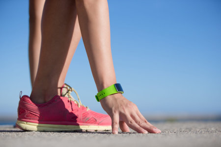 Health sport woman wearing smart watch device with touchscreen doing exercises