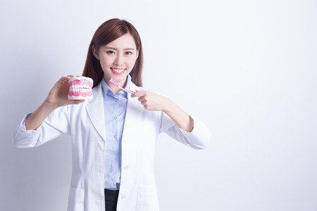 Smile woman dentist doctor teach you brush teeth. asianの写真素材