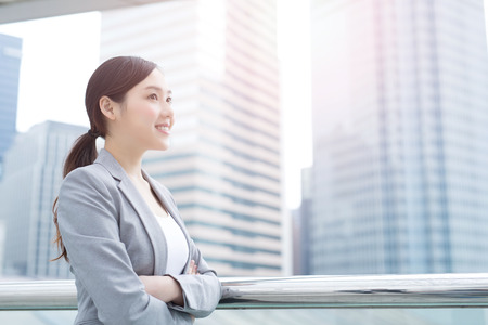 business woman smile and look with office background, asian beauty, shot in Hong Kongの写真素材