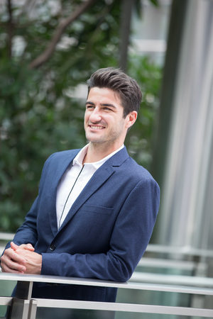 Business man smile with business office building background, caucasian, shot in Hong Kongの写真素材