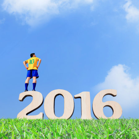 Brazil soccer player man stand on the 2016 text with blue sky