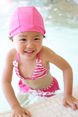 little cute girl wear swimsuit play happily and exciting in the swimming pool, asianの写真素材