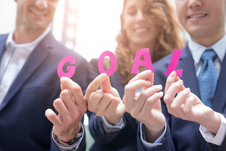 Business Goal concept - businesspeople happy show goal text, shot in hong kongの写真素材