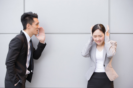 Businesspeopple is shoting angry with the gray wall in Hong Kong, asianの写真素材